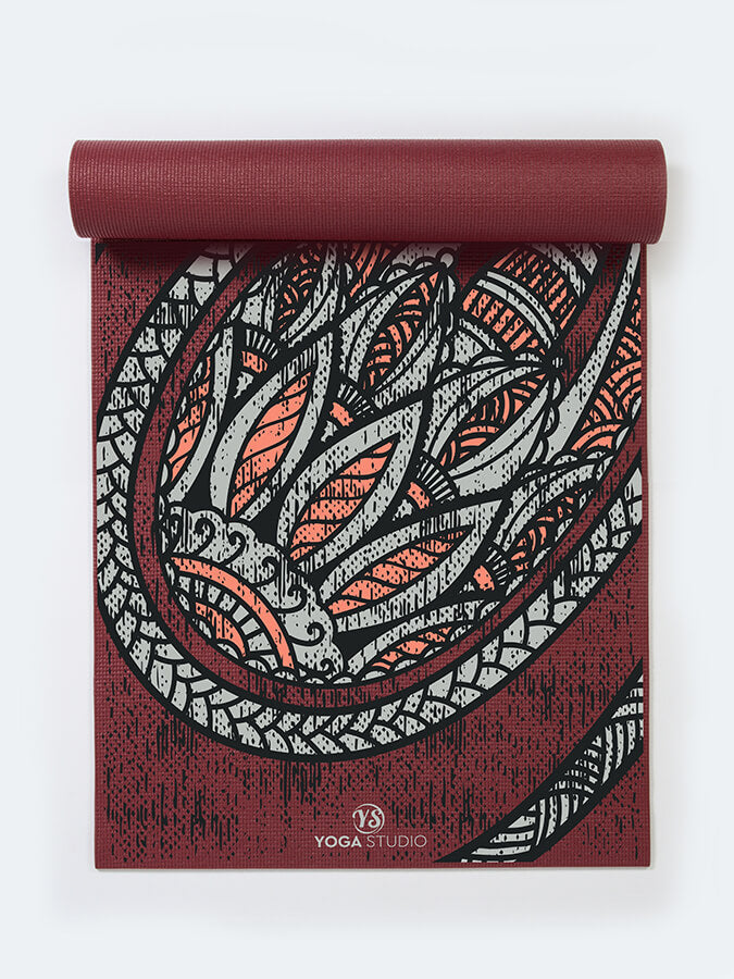 Yoga mat with dragon design on a white background