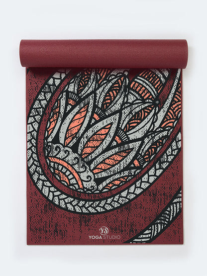 Yoga mat with dragon design on a white background