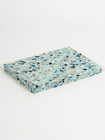 Multicolored terrazzo-style mat on a white background