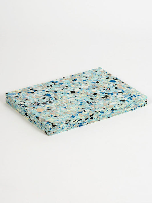 Multicolored terrazzo-style mat on a white background