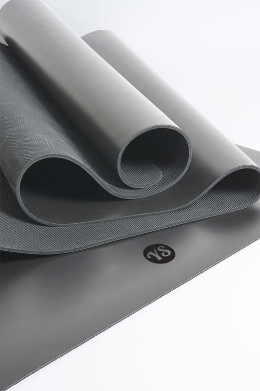Gray yoga mat with a brand logo on a white background