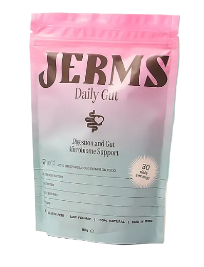 Jerms daily cat supplement package with a glass of juice and spoon on a light surface against a teal tiled wall.