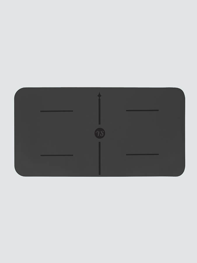 Black rectangular mat with central design on a light gray background