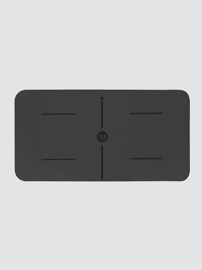 Black rectangular mat with central design on a light gray background