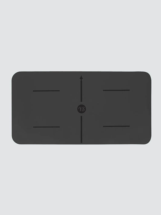 Black rectangular mat with central design on a light gray background