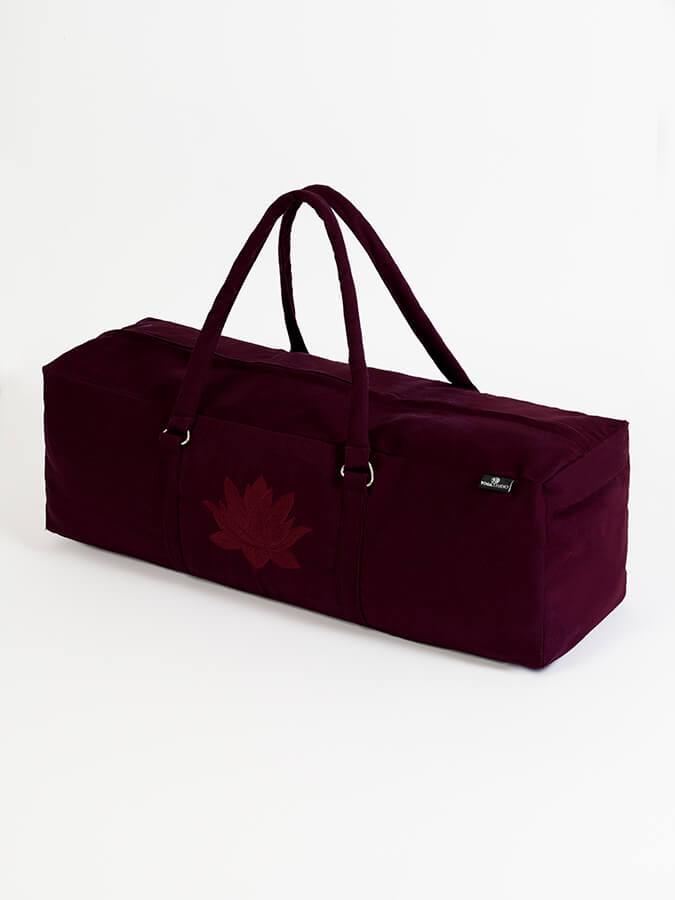 Maroon duffel bag with a leaf design on a white background