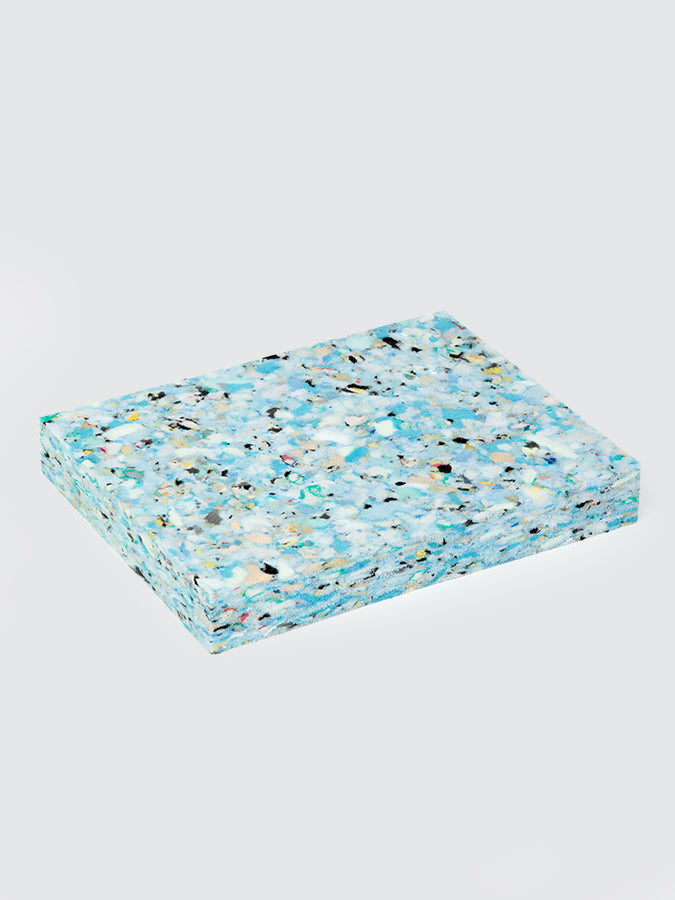 Speckled blue and beige cushion on a light gray background