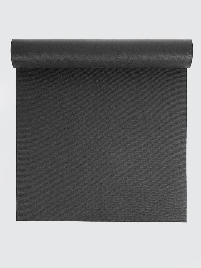Black yoga mat rolled up on a light gray background