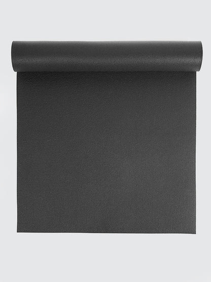 Black yoga mat rolled up on a light gray background