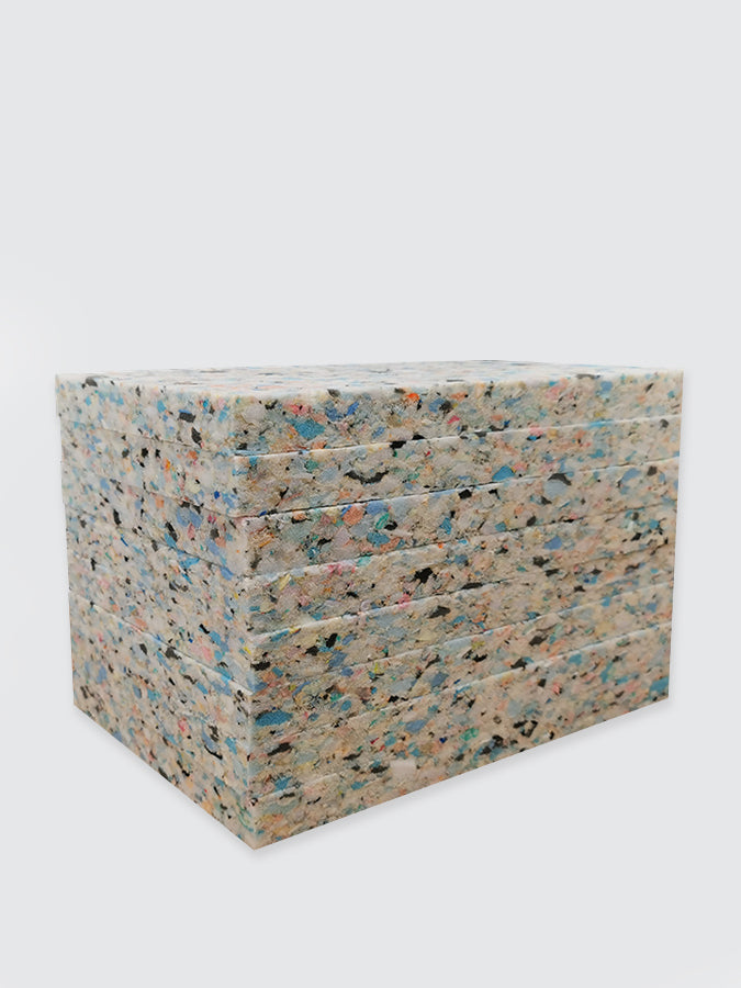Stack of colorful concrete blocks on a white background
