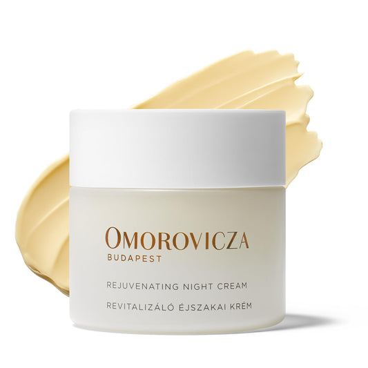 Omorovicza Rejuvenating Night Cream jar with a yellow leaf on a white background