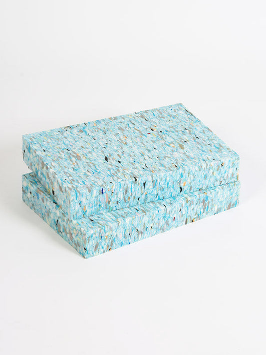 Two blue textured boxes stacked on a white background